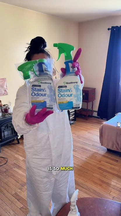 Brogan holding two EcoStrong stain and odor bottles